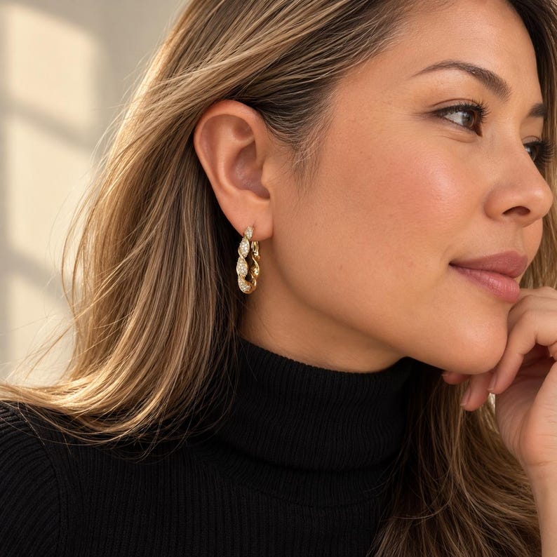 Profile view of twisted crystal pave hoop earring