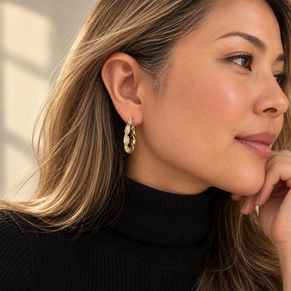 Profile view of twisted crystal pave hoop earring