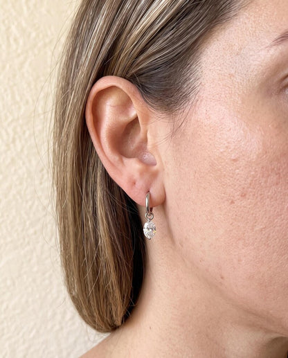 Side profile of person wearing moissanite huggie earring