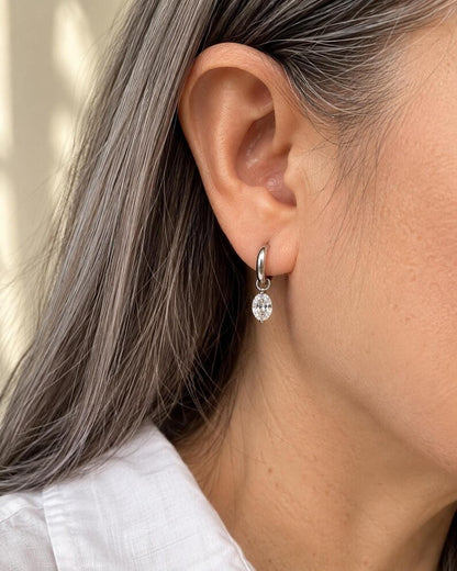 Close-up view of ear wearing moissanite huggie earring