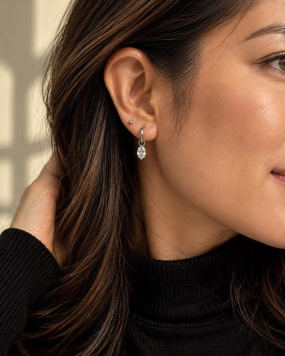 Side view wearing black top and moissanite huggie earring