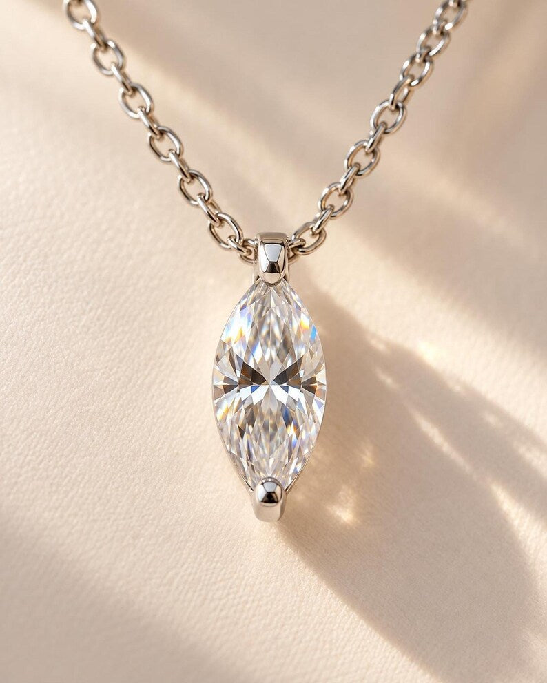 Faceted marquise gemstone in silver pendant setting