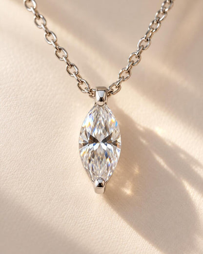 Faceted marquise gemstone in silver pendant setting