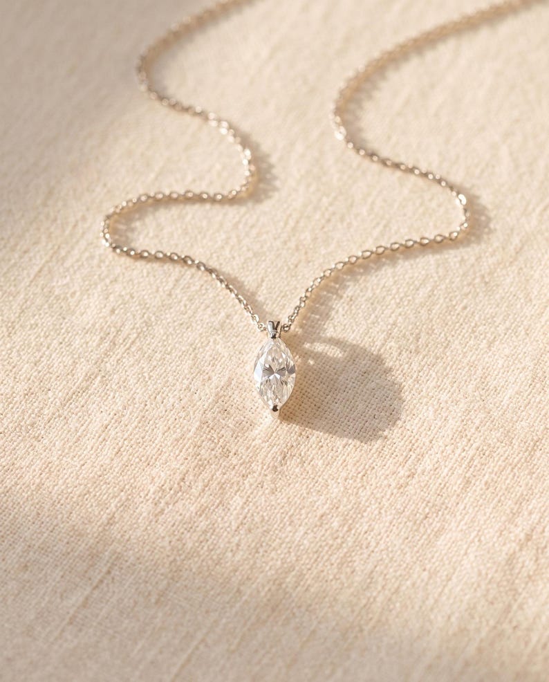 Marquise pendant necklace on neutral textured fabric